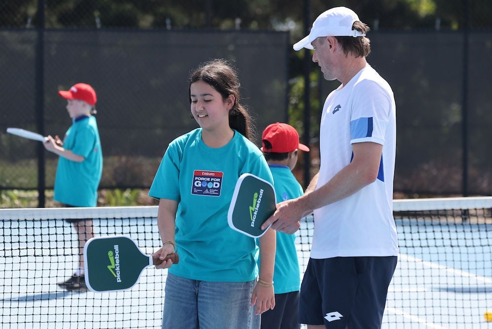 Tennis pro teaches paddle hold at an ATF Schools Future Fit event in Brisbane
