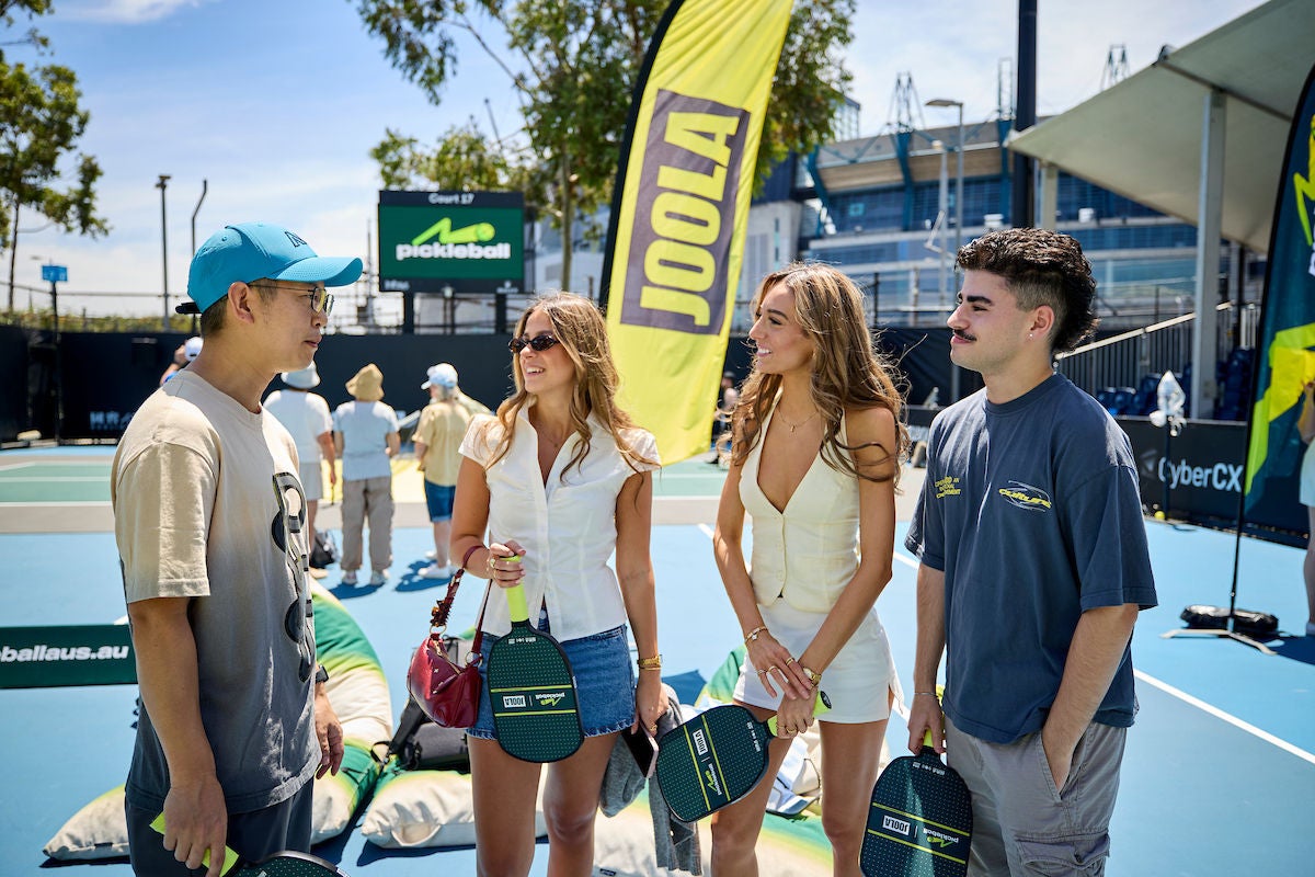 a group of young people having a discussion before heading onto the court.