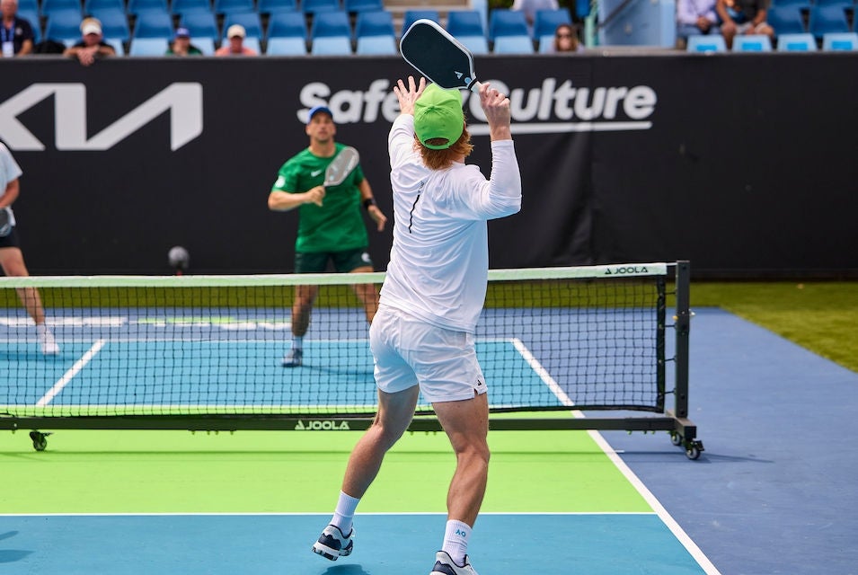 A male player serves during a game of doubles at the AO Pickleball Slam