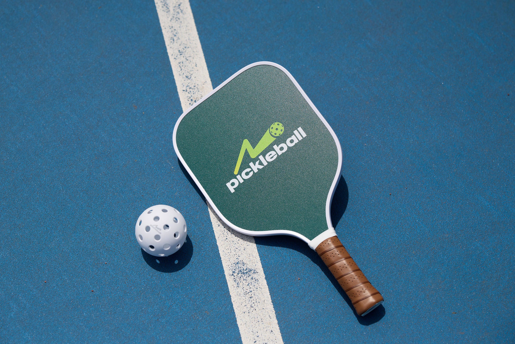 A pickleball racquet and a ball